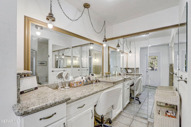 bathroom with tile patterned flooring and vanity