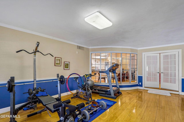 workout area featuring ornamental molding, hardwood / wood-style floors, and french doors