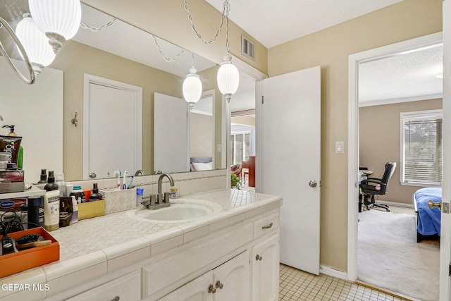 bathroom with vanity and a textured ceiling