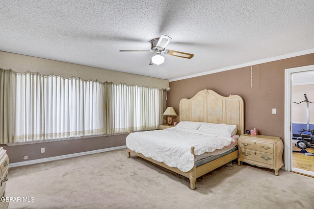 carpeted bedroom with multiple windows, a textured ceiling, ornamental molding, and ceiling fan