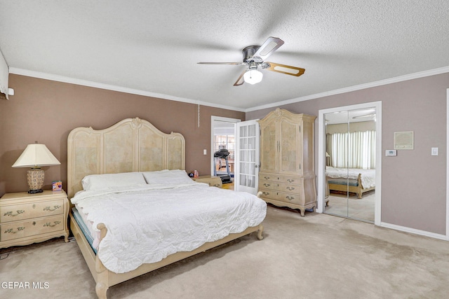 bedroom with crown molding, ceiling fan, a textured ceiling, light colored carpet, and a closet