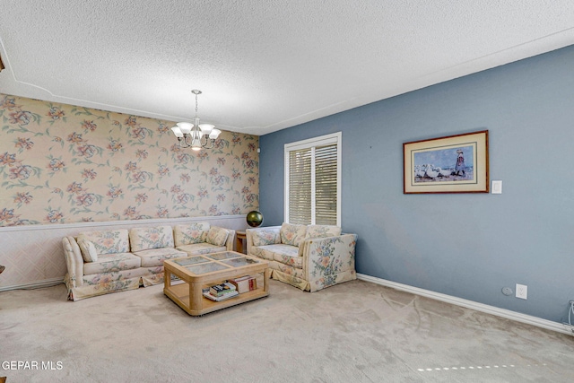 living room with an inviting chandelier, carpet, and a textured ceiling