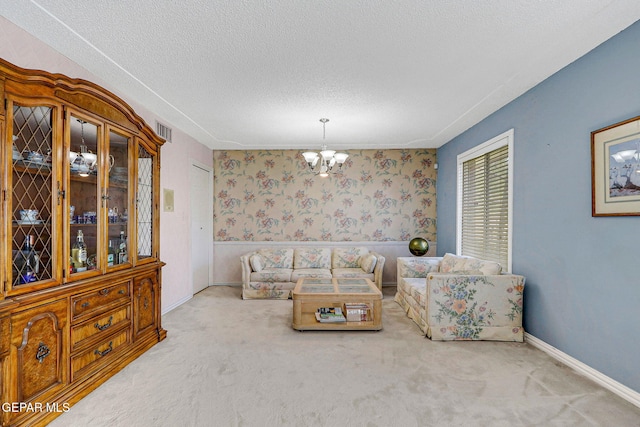 carpeted living room featuring a chandelier and a textured ceiling