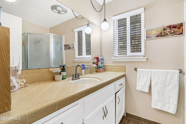 bathroom featuring vanity, tile patterned flooring, and walk in shower