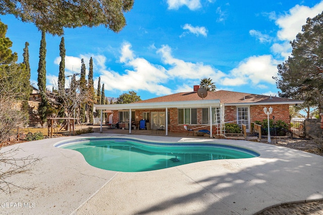 view of swimming pool with a patio area