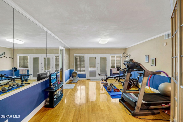 workout area with crown molding, hardwood / wood-style flooring, french doors, and a textured ceiling