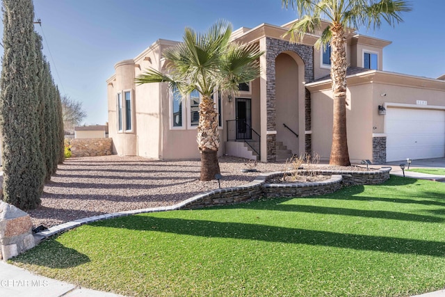 mediterranean / spanish-style house featuring a garage and a front yard