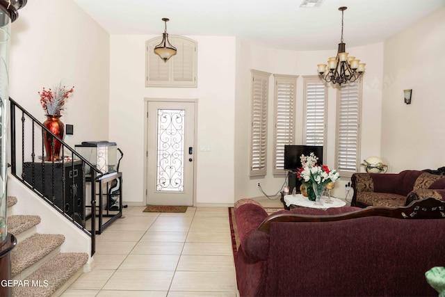 tiled foyer featuring a chandelier