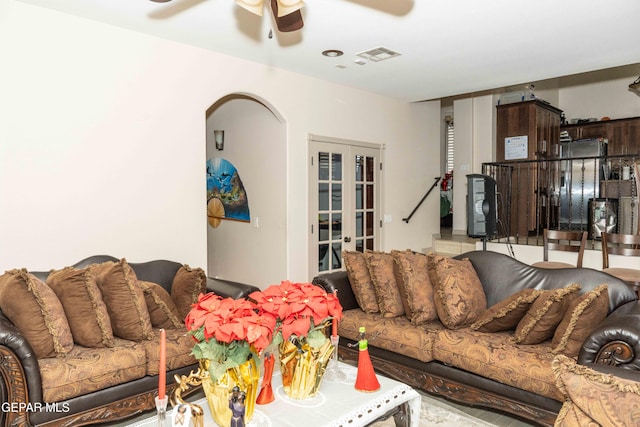 living room featuring french doors and ceiling fan