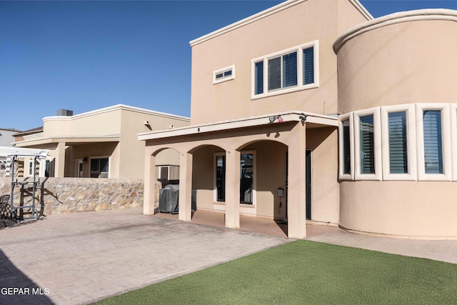 back of house with a patio