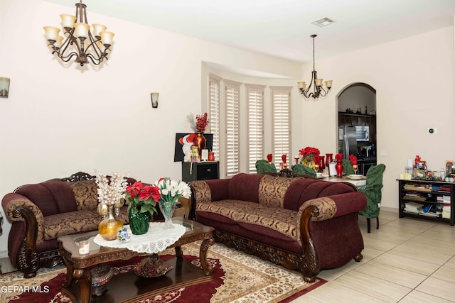 living room with tile patterned flooring and an inviting chandelier