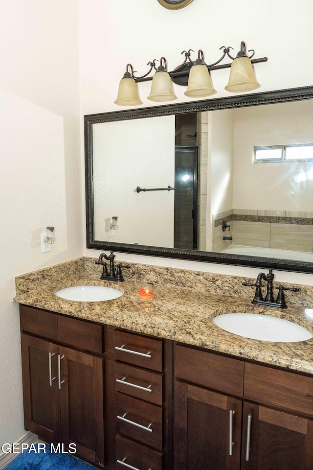 bathroom with independent shower and bath and vanity