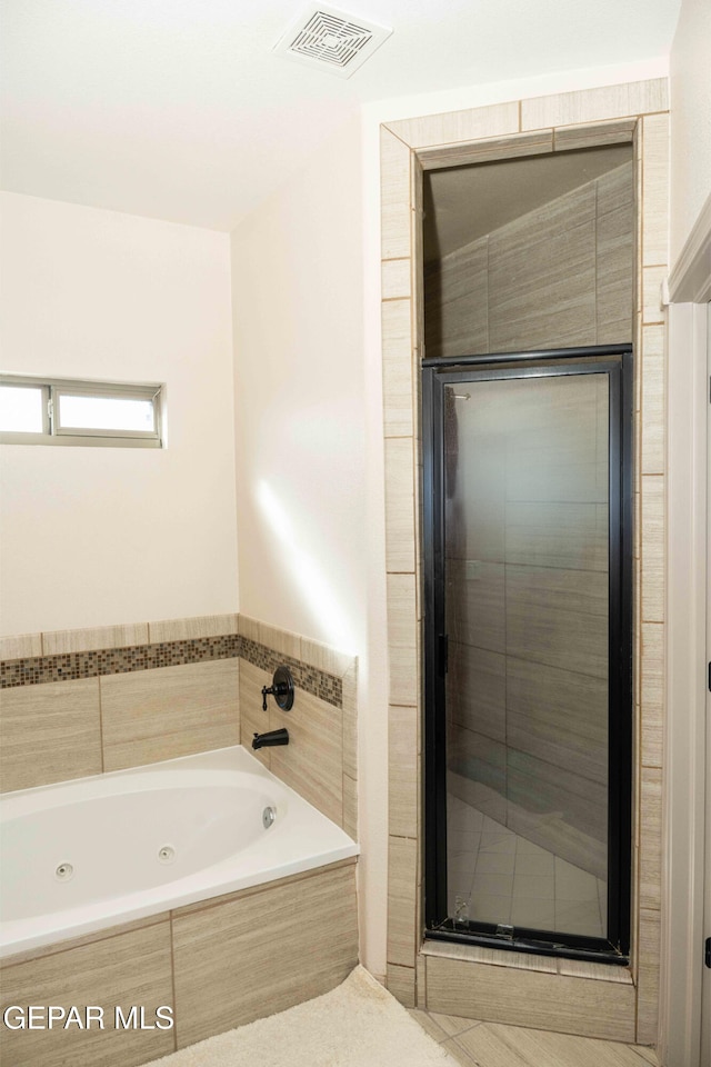 bathroom with separate shower and tub