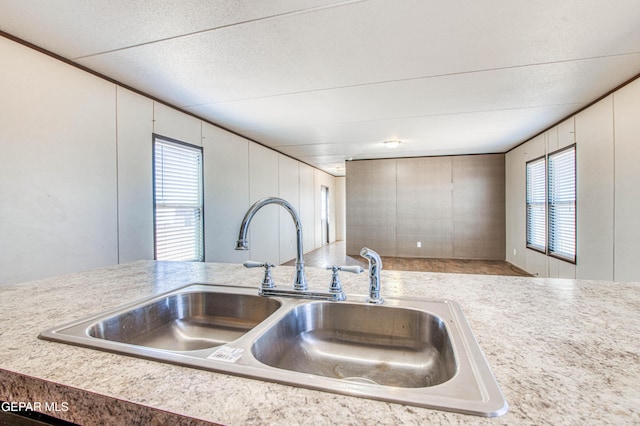 kitchen featuring white cabinetry, sink, and a textured ceiling