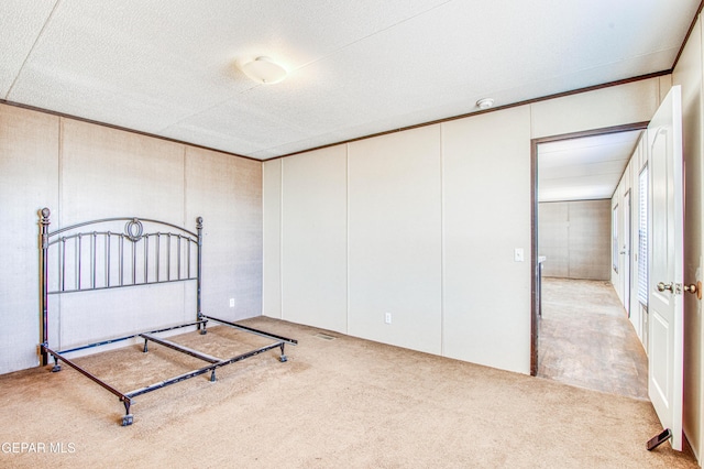 unfurnished bedroom with light colored carpet