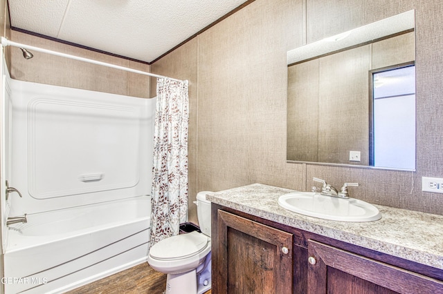 full bathroom featuring shower / bath combo, hardwood / wood-style floors, vanity, a textured ceiling, and toilet