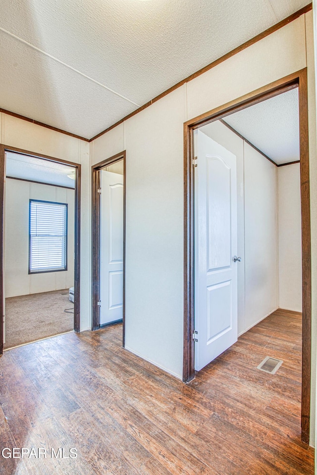 empty room featuring hardwood / wood-style floors and a textured ceiling