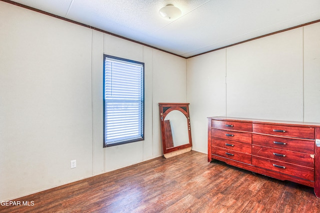 bedroom with ornamental molding, dark hardwood / wood-style floors, and a textured ceiling