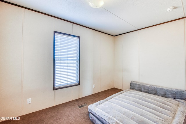 carpeted bedroom with ornamental molding