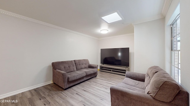 living room featuring crown molding, light hardwood / wood-style flooring, and a healthy amount of sunlight