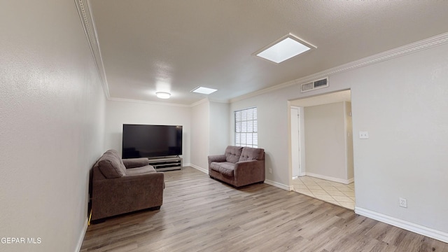 living room featuring crown molding, a textured ceiling, and light wood-type flooring