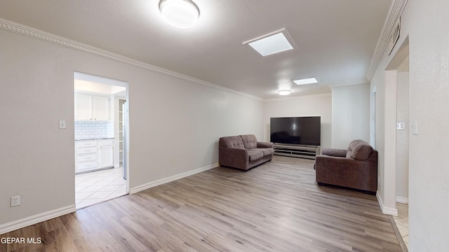 unfurnished living room with crown molding and light hardwood / wood-style floors