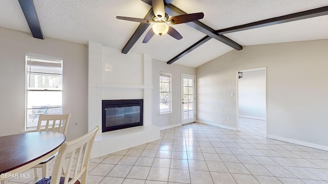 unfurnished living room featuring vaulted ceiling with beams, a large fireplace, light tile patterned floors, and a textured ceiling