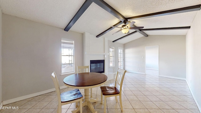 unfurnished dining area featuring plenty of natural light, vaulted ceiling with beams, light tile patterned floors, and a textured ceiling