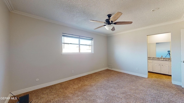 spare room with light carpet, ceiling fan, ornamental molding, and a textured ceiling