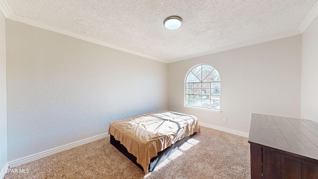 bedroom featuring crown molding, light colored carpet, and a textured ceiling