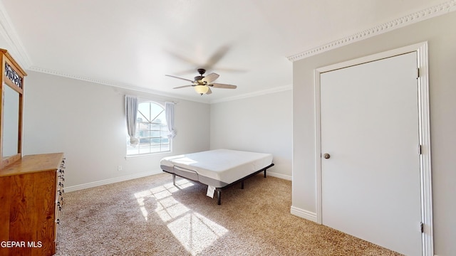 carpeted bedroom with crown molding and ceiling fan