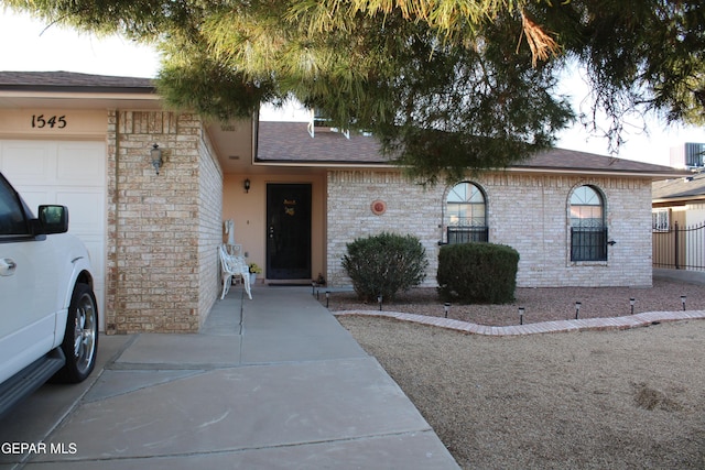 single story home with a garage and central AC