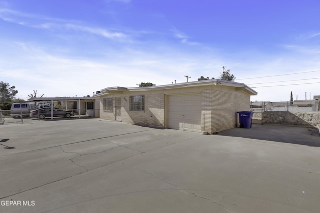 back of house featuring a carport and a garage