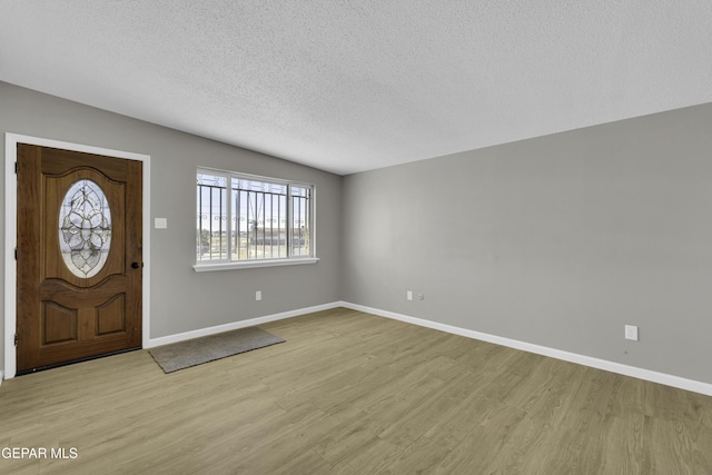 entryway featuring a textured ceiling and light wood-type flooring