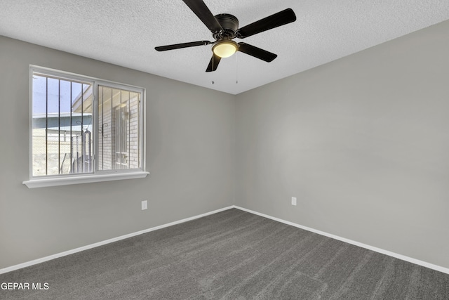 carpeted empty room with a textured ceiling