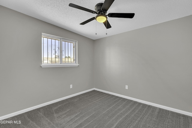 empty room with ceiling fan, carpet, and a textured ceiling