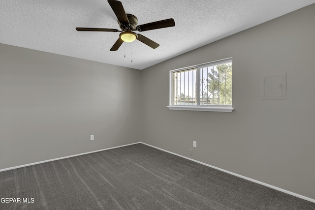 carpeted spare room with ceiling fan and a textured ceiling