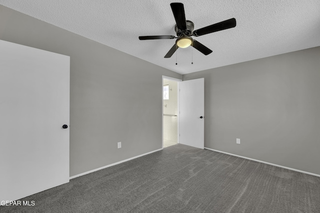 spare room with ceiling fan, a textured ceiling, and carpet