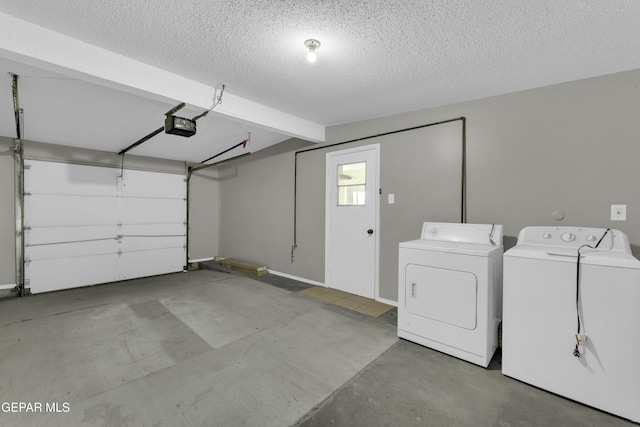 garage featuring a garage door opener and independent washer and dryer