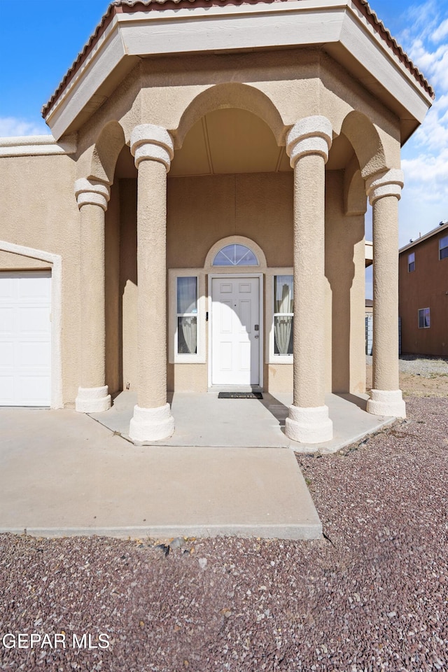 view of exterior entry with a garage