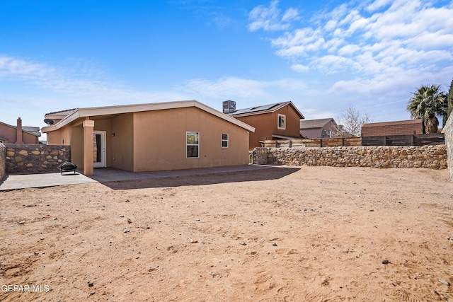 back of property featuring cooling unit and a patio