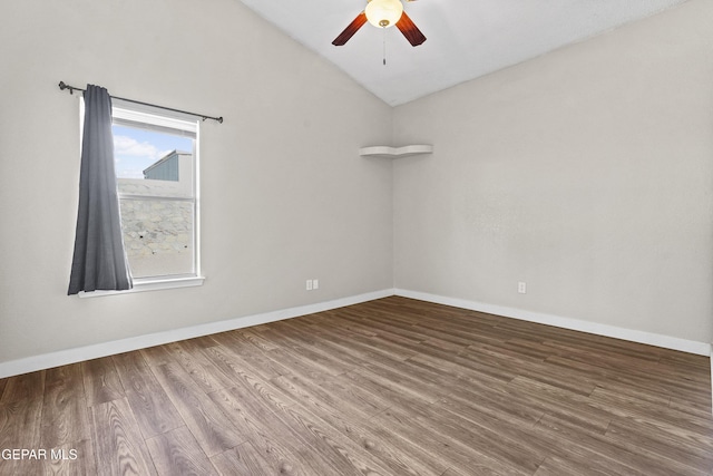 empty room with wood-type flooring, ceiling fan, and vaulted ceiling