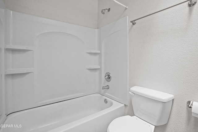 bathroom featuring  shower combination and toilet