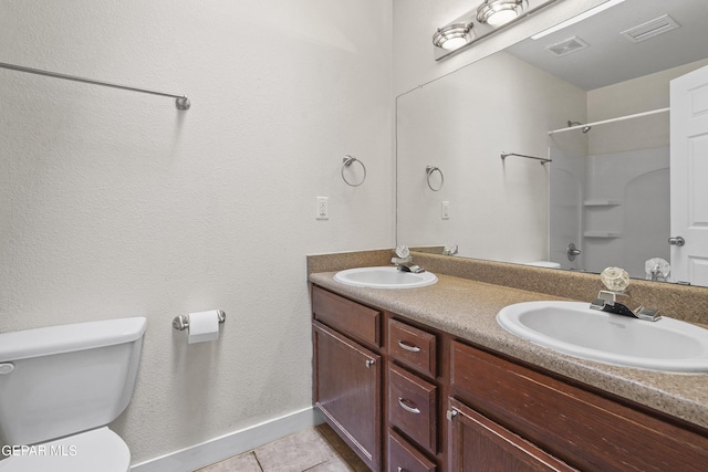 bathroom featuring walk in shower, tile patterned floors, toilet, and vanity