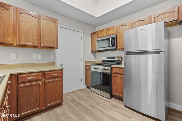 kitchen featuring stainless steel appliances and light wood-type flooring