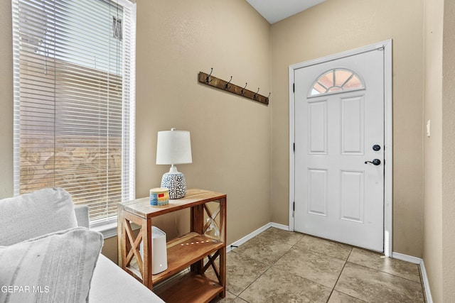 foyer entrance featuring light tile patterned flooring