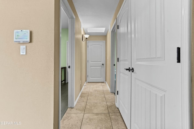 hall featuring light tile patterned floors