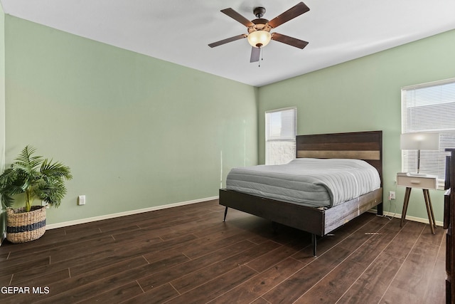 bedroom with dark hardwood / wood-style floors and ceiling fan