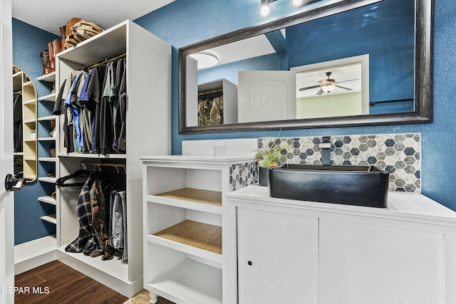 spacious closet featuring sink, hardwood / wood-style floors, and ceiling fan