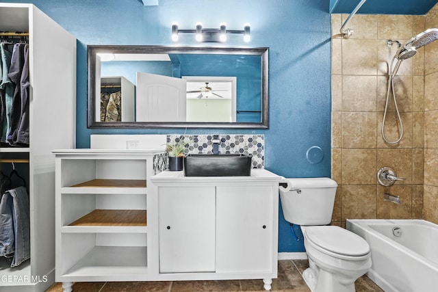 full bathroom with sink, toilet, tiled shower / bath, and ceiling fan